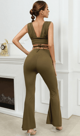 Open-back top and high-waisted bootcut trousers.